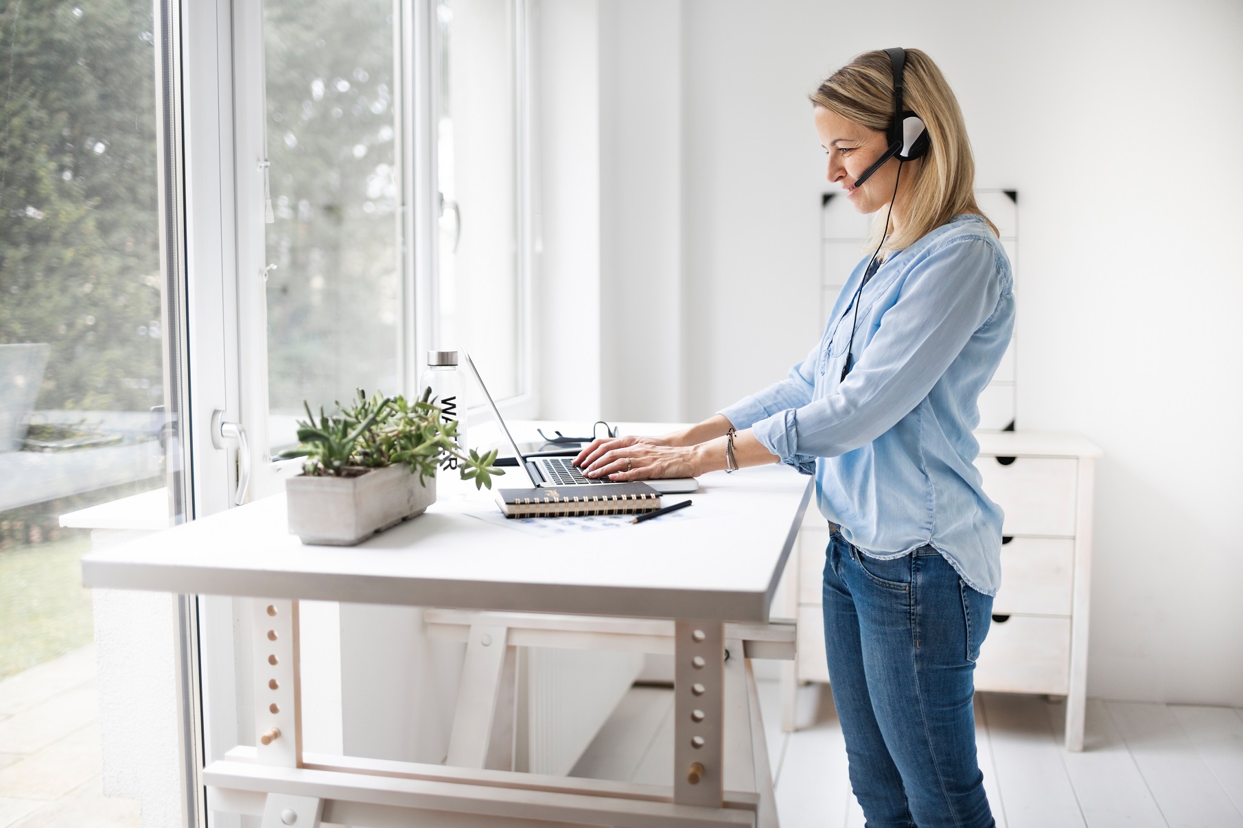 Businesswoman working at ergonomic standing desk